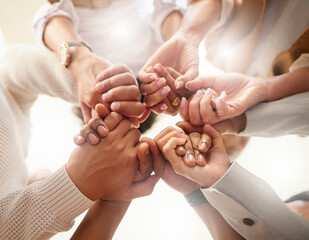 Office, teamwork and holding hands in circle for team building, trust and motivation at startup...