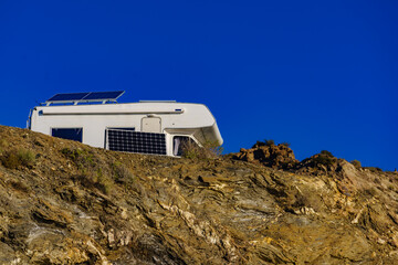 Caravan with tilt solar panels on roof.