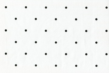The texture of natural white cotton fabric with polka dots. Background of a simple natural thin...