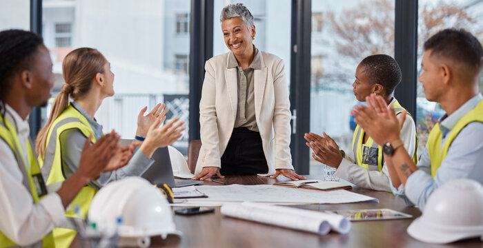 Applause, talking and construction workers in a meeting with a manager for architecture success. Happy, team and architects clapping for a presentation from a boss about infrastructure design