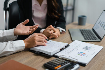 Businessman showing business data in notebook and explaining about new startup project to executive