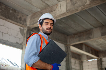 handsome caucasian engineer working at construction site.