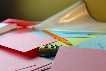 A close up photo of a school student's pencil on an array of colourful flashcards. 