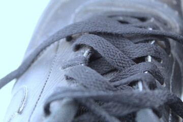 A photo of a student's school black shoe laces against a white background. 