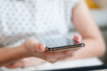 Close up of Hand holds a smartphone with a touch screen, The screen's interface displays a blank yet dynamic canvas for communication. A world of apps, social networking, and online connection unfolds