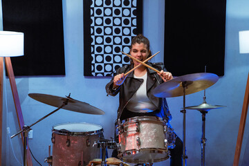 Young female drummer starting a drum session