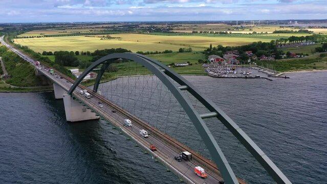 Drone shot, drone video, drone flight, aerial view, flight over the Fehmarnsund bridge with flowing traffic, truck, car, train, strait near Fehmarn island, wide view over the island, Baltic Sea