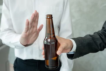 Foto op Plexiglas man refuses say no and avoid to drink alcohol at work, stopping hand sign male, alcoholism treatment, alcohol addiction, quit booze, Stop Drinking Alcohol. Refuse Glass liquor, unhealthy, reject © Shisu_ka