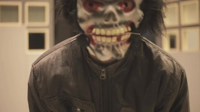 Cinematic jumpscare shot of a man dressed in a Halloween costume and scaring people in a corporate office, HD Footage - 24 fps - ProRes