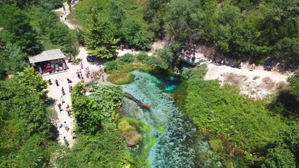 Aerial drone view of the cold water river of The Blue Eye or Syri i kalter in the mountains of southern Albania