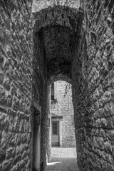 An arched alleyway in a quiet back street in the historic coastal city of Split in Croatia