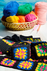 Knitted zigzag handmade ornaments and skeins of multi-colored threads.