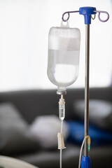 An iron stand to hang saline bottle high to deliver saline via catheter to an intravenous patient...