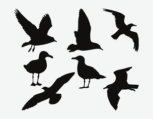 Obraz premium Graceful Seagull Silhouettes Set, Majestic Coastal Birds in Diverse Flying Poses and Resting Stances for Art and Design Projects