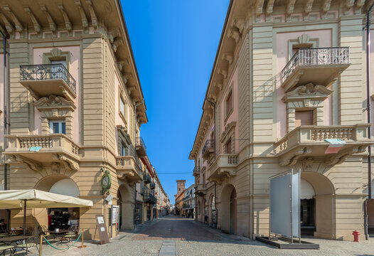 Alba, Langhe, Italy - August 20, 2023: Via Vittorio Emanuele the main pedestrian street between historic buildings, called via Maestra (Main street) , seen from piazza Ferrero...