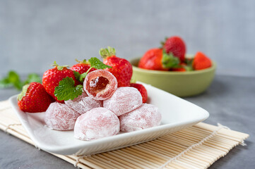 Strawberry mochi on a plate, rice asian sweets.