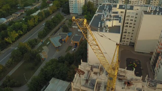 The impressive details of a yellow construction crane in operation. A close look at the mechanisms laying the foundation for a modern future