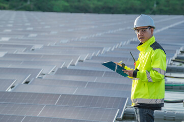 Asian engineer working at Floating solar power plant,Renewable energy,Technician and investor solar panels checking the panels at solar energy installation