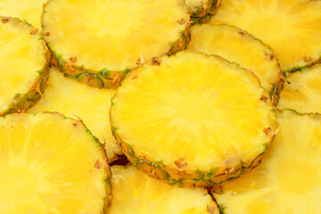 Pineapple juicy yellow slices as a background.