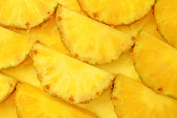 Pineapple juicy yellow slices as a background.