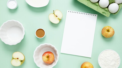 Ingredients for making classic cake pie with apples on green background. Concept homemade food, seasonal pastries. Top view, copy space