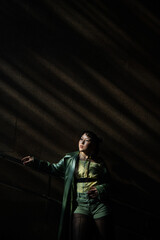 Portrait of a young Asian woman posing in the subway near the stairs. 