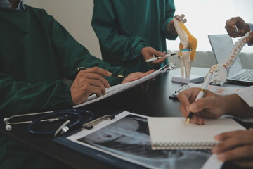 Group of doctors reading a document in meeting room at hospital