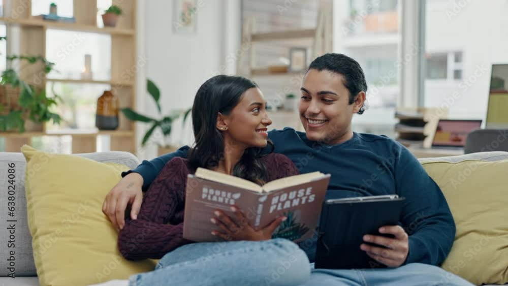 Wall mural Reading a book, tablet and couple on a home sofa for search, internet and knowledge or relax. Happy man and woman together on couch with technology and story for entertainment, learning or connection