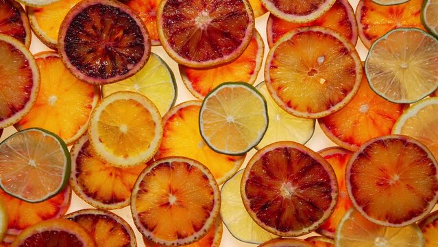 Background of Sliced Oranges, Lemons, and Limes in Ring Form