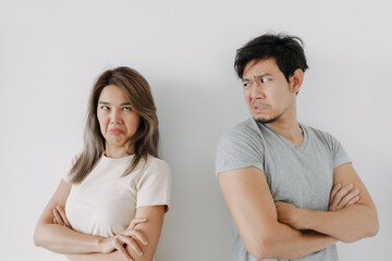 Funny angry face asian couple mad and fight at each other isolated on white.