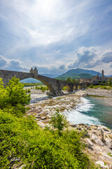 Fototapeta premium Gobbo Bridge also Devil Bridge or Ponte del Diavolo or Ponte Gobbo in Bobbio, Piacenza province, Trebbia Valley, Emilia Romagna, Italy