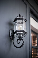 Vintage iron lantern old classic wall lamp, outdoor garden street wall metal electrical lamp in town or village. 