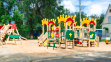 Abstract blur Children playground. Empty colorful children playground set in park. Outdoor playground. Sandy ground