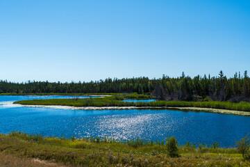 Beautiful lake sparkles in sunshine in Behchoko, Northwest territories, Canada