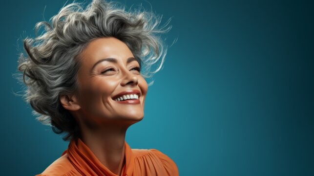 a woman laughing emotionally against a colorful background