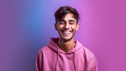 Smiling indian young man on lilac background.
