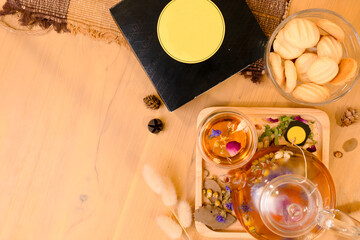 Flowers Teapot with a cup of tea and butter cookies , Top view with text space 2