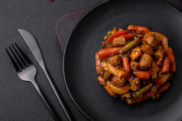 Mix of vegetables corn, carrots, peppers, broccoli, onions in teriyaki sauce on a ceramic plate