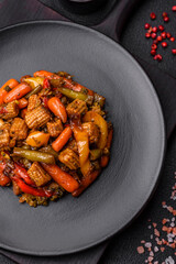 Mix of vegetables corn, carrots, peppers, broccoli, onions in teriyaki sauce on a ceramic plate