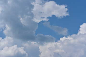 Naklejka na ściany i meble Blue-white thunderclouds in summer. Cumulative clouds.