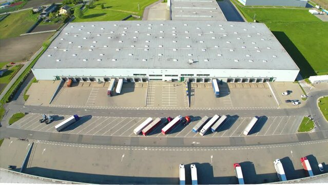 Aerial view of distribution center, drone photo of industrial logistics zone,new super modern logistics center full of modern technology and robotics,roof solar power plant for green energy production