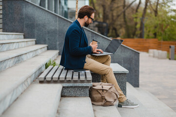 Obraz premium handsome busy bearded man working in park