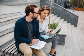 man and woman working together in park