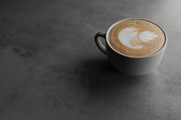 Closeup hot coffee latte art cup on table