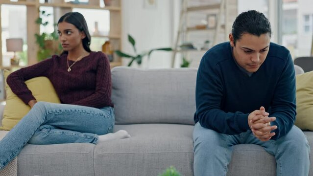 Couple, counseling and conflict on sofa in fight, argument or divorce discussion in living room with angry, dispute or disagreement. Frustrated, woman and man with confession of cheating or mistake