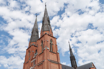 Naklejka premium Uppsala Cathedral in Uppsala, Sweden on sky with clouds background
