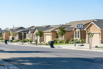 New cottages along a street in a housing development on a clear autumn day