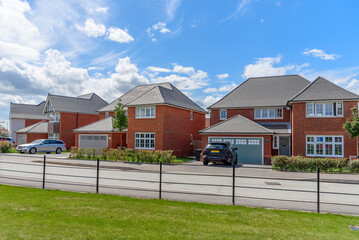 Row of newly built houses along a street on a clear summer day