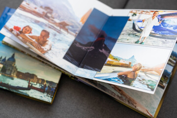 Family photos archive saved in brightly designed photo book; bright summer memories placed in the...