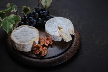 Cheese with white mold. Camembert cheese on wooden board. Natural product made from milk.Copy space.